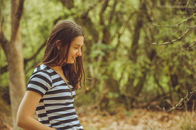 Side view of young woman standing on land