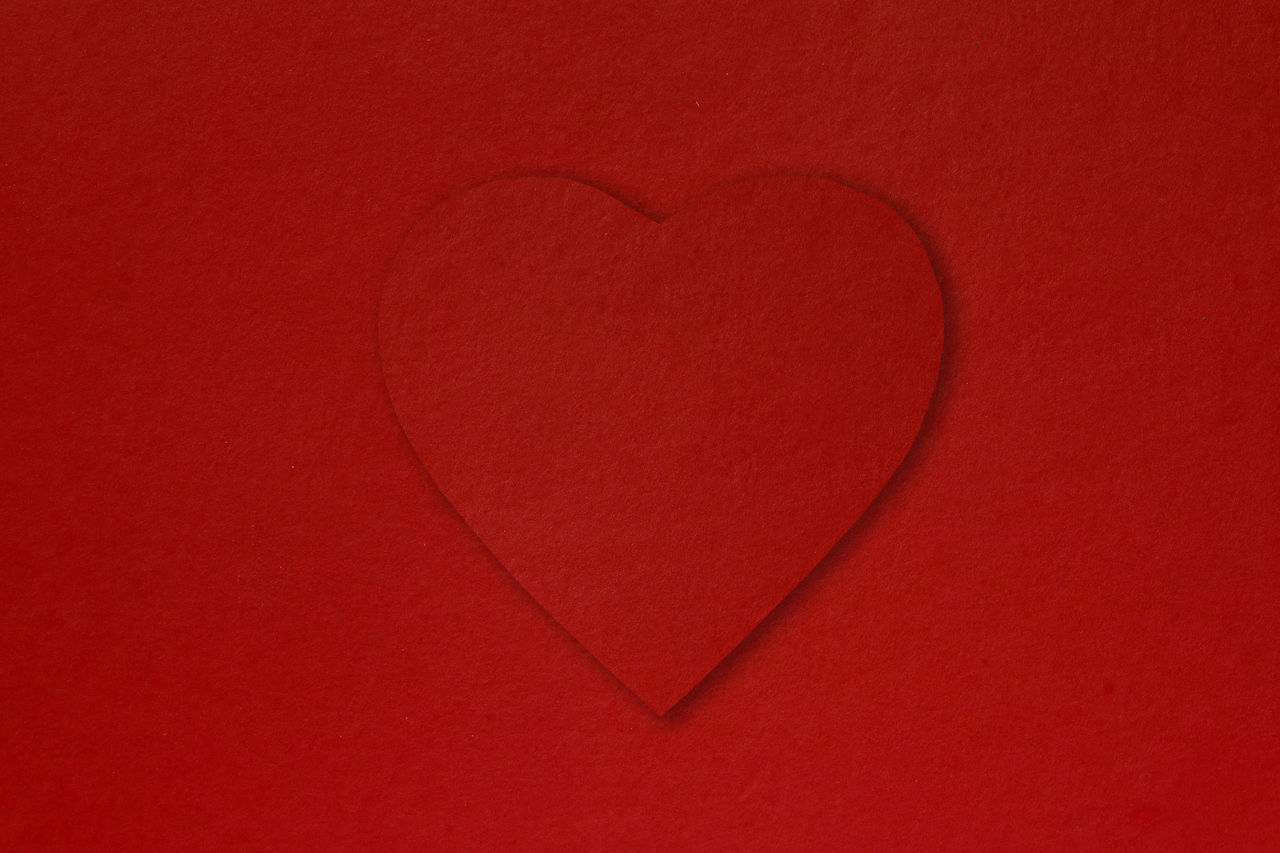 CLOSE-UP OF HEART SHAPE ON RED