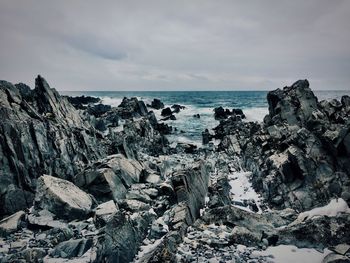 Scenic view of sea against cloudy sky