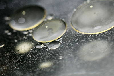 High angle view of raindrops on glass table