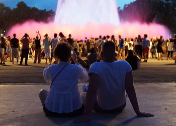 Rear view of people dancing at music concert