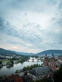 High angle view of townscape by river against sky