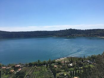 Scenic view of lake against clear blue sky