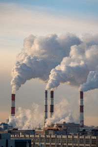 Buildings in city against sky during sunset