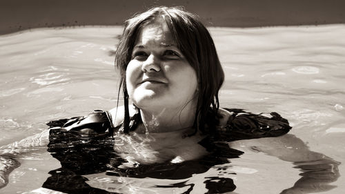 Portrait of a smiling woman swimming in water