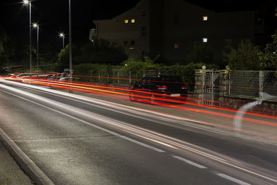 Light trails on road in city at night