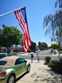 View of flags on street against sky