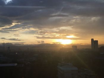 Scenic view of buildings against sky during sunset