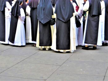 Low section of people standing on footpath