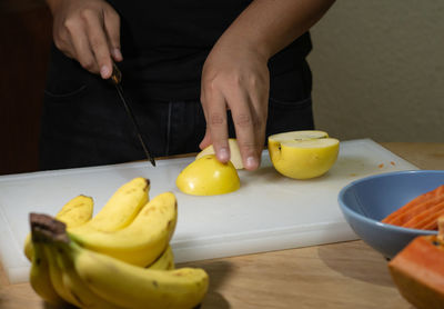 Midsection of man preparing food on table