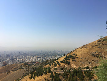 Aerial view of city and buildings against clear sky