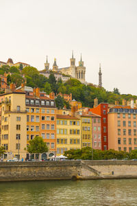 Buildings in city against clear sky