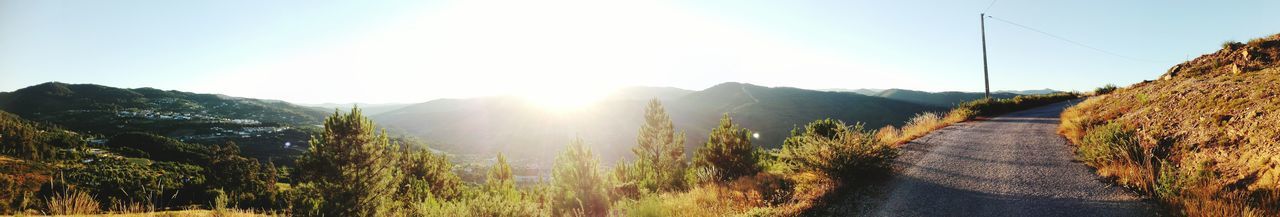 Panoramic view of road by mountains against sky