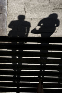 Shadow of people sitting on staircase