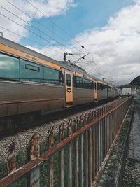 Train at railroad station against sky