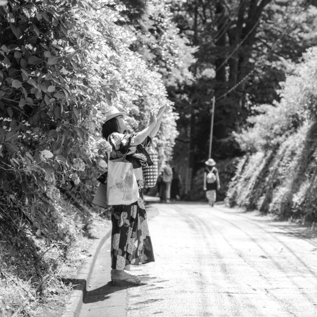 FULL LENGTH OF MAN STANDING BY ROAD