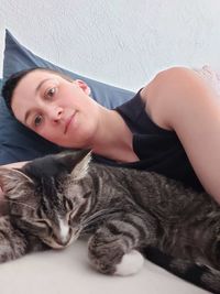 Portrait of cat lying down on sofa