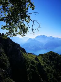 Scenic view of mountains against clear blue sky