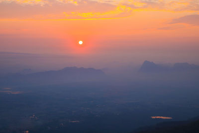 Scenic view of dramatic sky over landscape during sunset