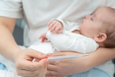 Midsection of doctor examining patient