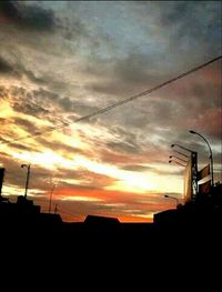 Silhouette of building against dramatic sky