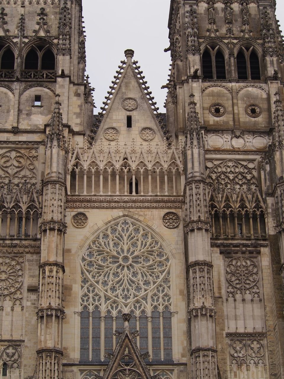 architecture, building exterior, built structure, church, religion, low angle view, place of worship, spirituality, cathedral, history, arch, cross, window, facade, travel destinations, old, famous place, day