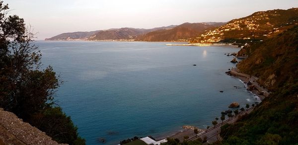 High angle view of sea and mountains against sky