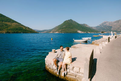 Panoramic view of people on sea against clear sky