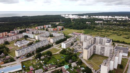 High angle view of buildings by sea against sky