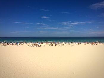 Scenic view of beach against blue sky