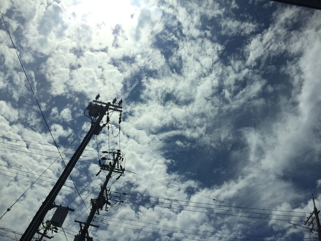 LOW ANGLE VIEW OF ELECTRICITY PYLON AGAINST CLOUDY SKY