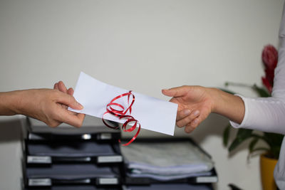 Woman receiving envelope from man