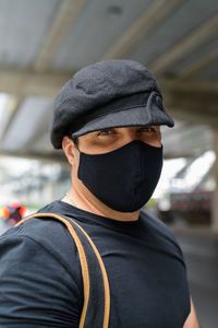 Portrait of man wearing hat standing outdoors