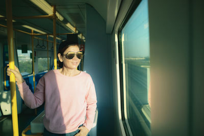 Woman standing by train