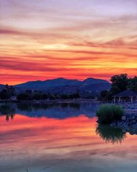 Scenic view of lake against orange sky