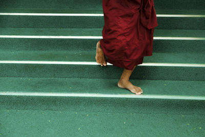 Low section of man walking on steps