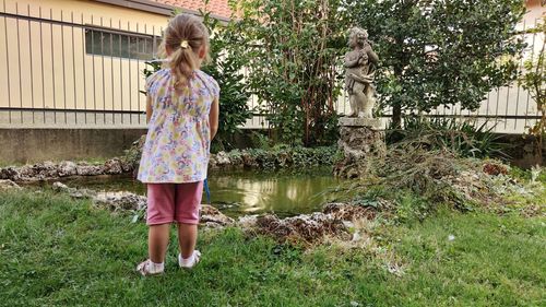 Full length of woman standing in yard
