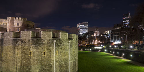 Tower of london at night with skyscrapers in background