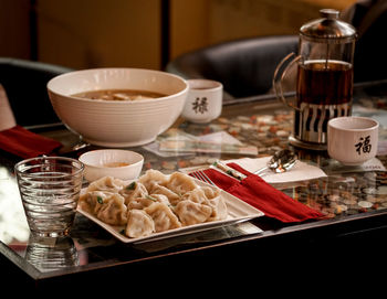 Close-up of chinese food in glass on table