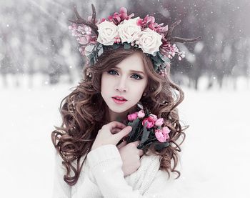 Woman holding flowers in snow