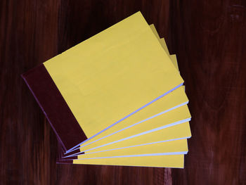 High angle view of yellow paper on table