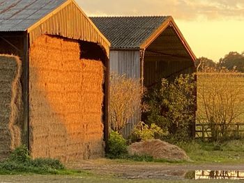 Barn on field by house