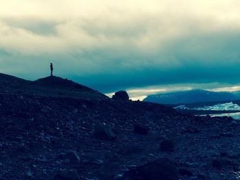 Scenic view of mountains against cloudy sky