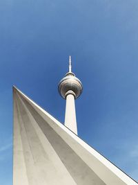 Low angle view of communications tower against sky