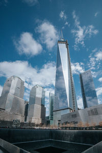 Low angle view of buildings against cloudy sky