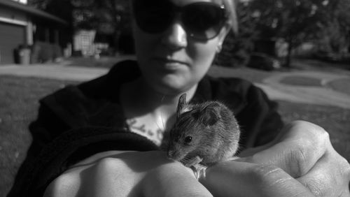 Close-up portrait of woman with mouse in city