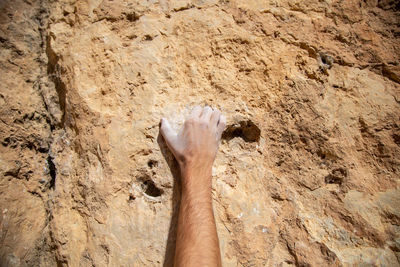 High angle view of human feet on rock
