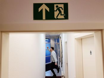 Full length of man standing at entrance of building