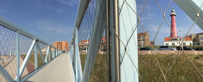 Panoramic shot of bridge on field against sky