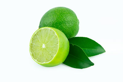 Close-up of green fruit against white background
